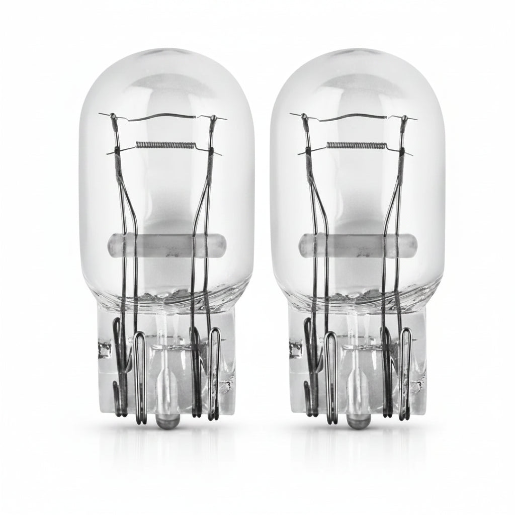 Two clear automotive light bulbs on a white background