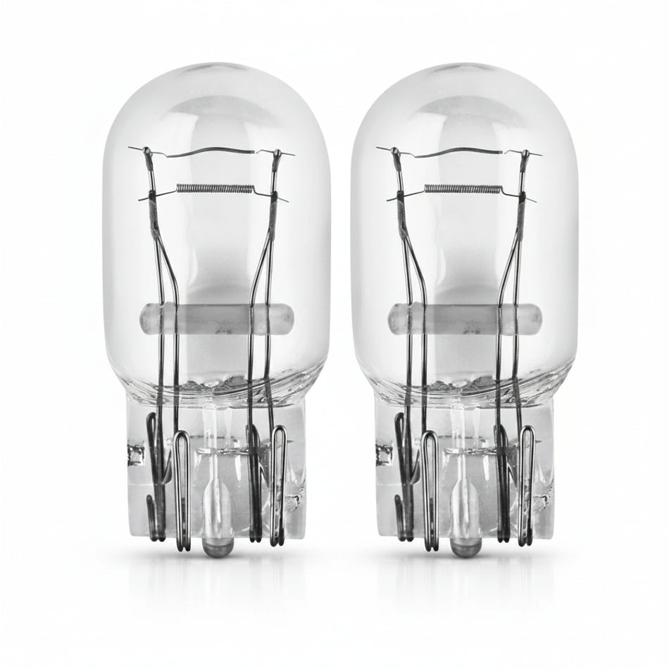 Two clear automotive light bulbs on a white background