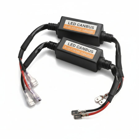 Two black LED CANBUS amplifier adapters with red and black wires and clear terminal connectors, shown on a white background.